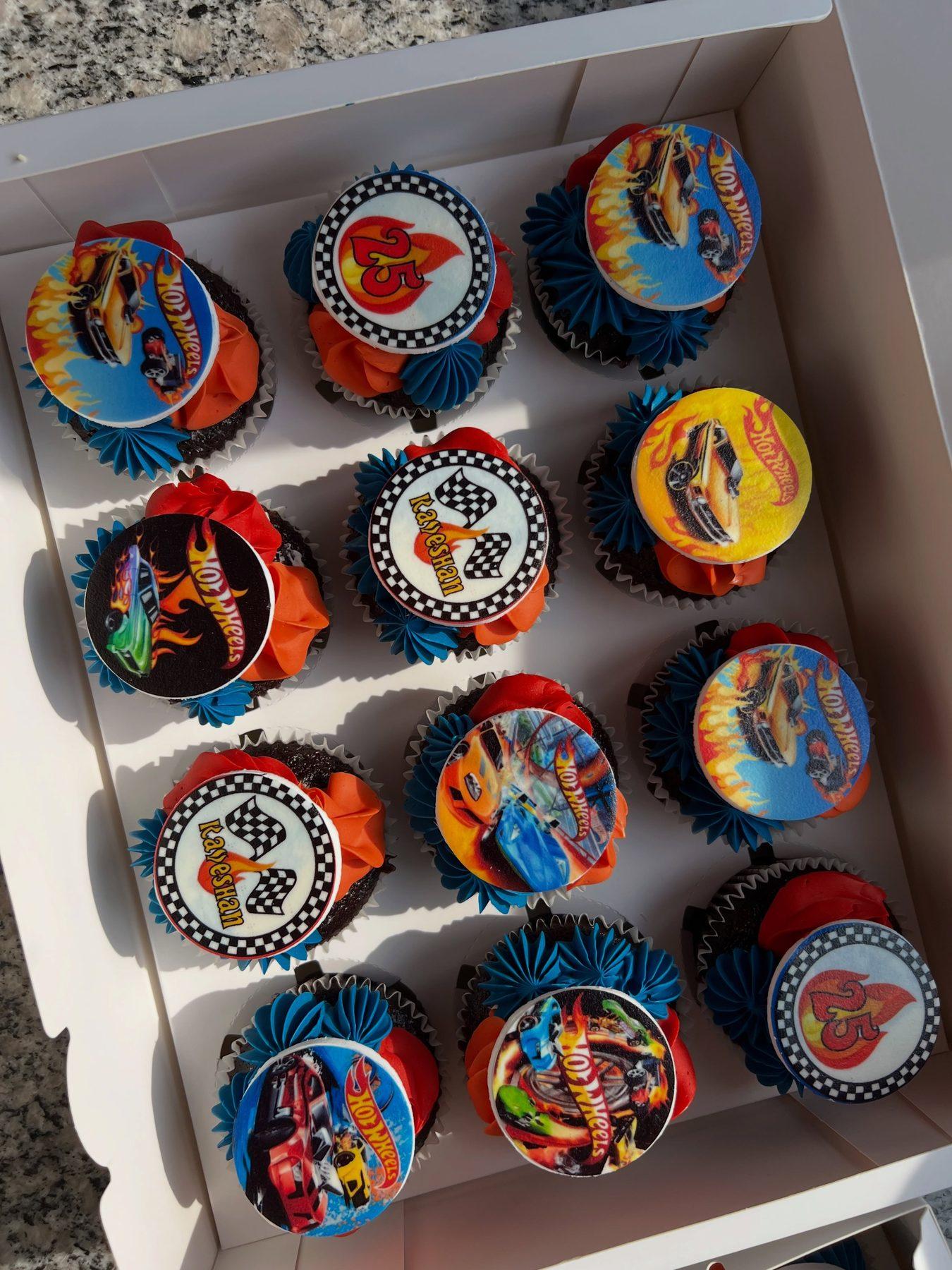 Hot Wheels-themed cupcakes with flame and checkered-flag toppers, personalised for a 25th birthday